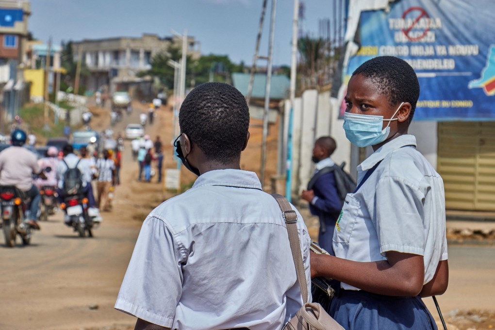 Congolese children wear face masks as they walk along a street in Bunia, Ituri province, on Wednesday as aid agencies intensify efforts to contain a new Ebola outbreak. Photo: Reuters