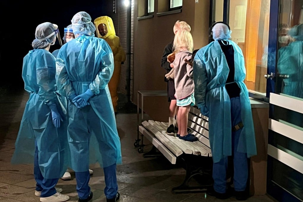 The children of an American Ebola patient look through a window at their father in an isolation ward at a hospital in Berlin, Germany, on Thursday. Photo: Handout via Reuters