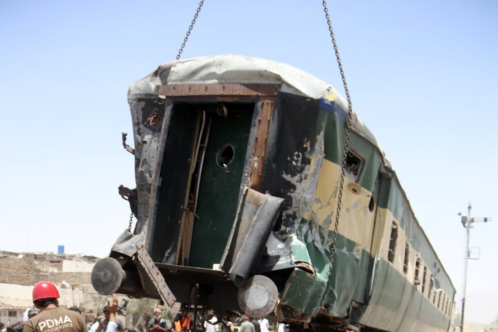 A wrecked carriage is lifted at the scene of a deadly train blast in Quetta, Pakistan, on Sunday. Photo: EPA