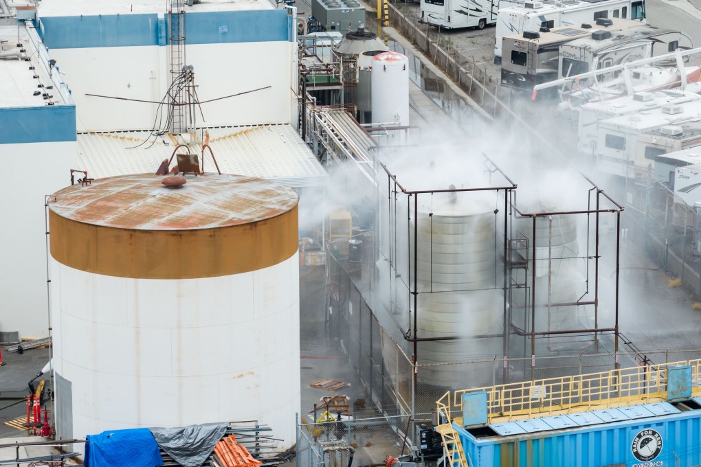 Firefighters have been spraying water to cool the tank. Photo: AP