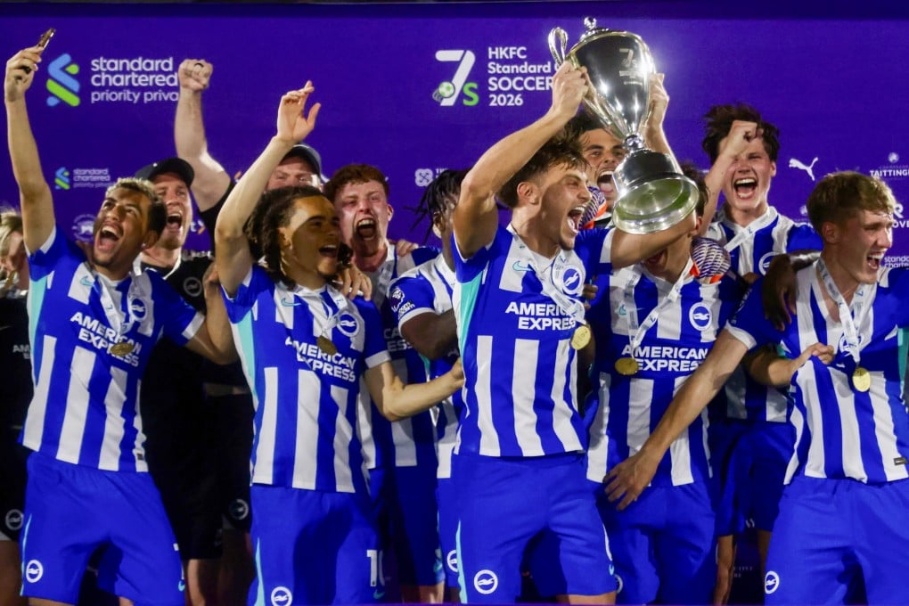 Captain Josh Robertson hoists the trophy and Tyler Silsby (far left) captures the moment, as Brighton celebrate their second Hong Kong success in three years. Photo: Jonathan Wong