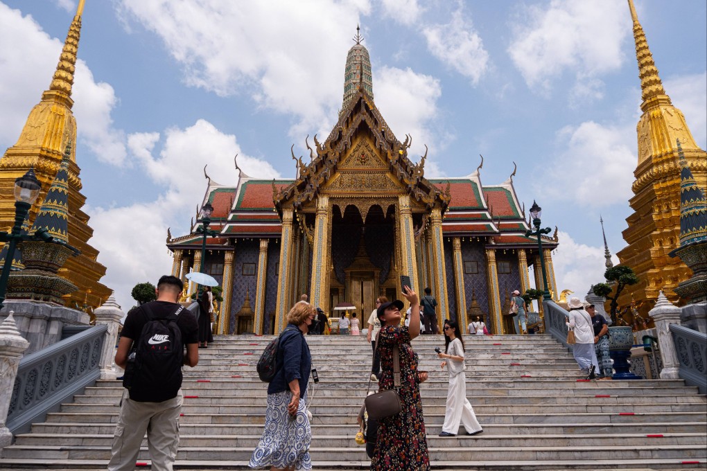 Tourists visit the Temple of the Emerald Buddha in Bangkok. Thailand has announced the removal of the 60-day visa-free entry for tourists. Photo: Peerapon Boonyakiat/SOPA Images