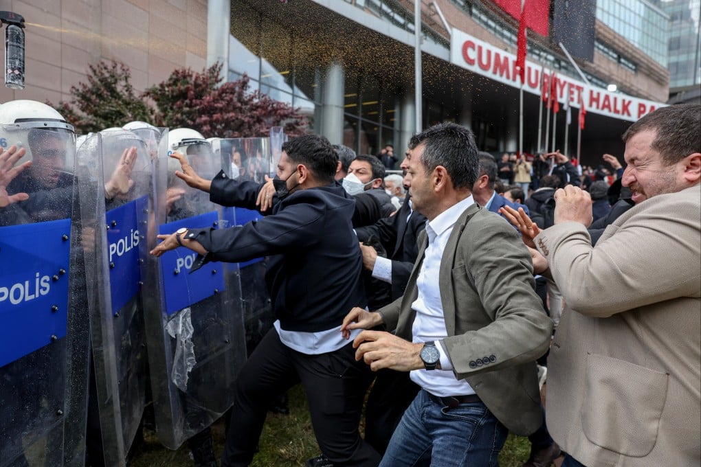 Police officers storm Turkey’s main opposition Republican People’s Party (CHP) headquarters to evict supporters gathered inside for party leader Ozgur Ozel, in Ankara on Sunday. Photo: Dia Photo via AP