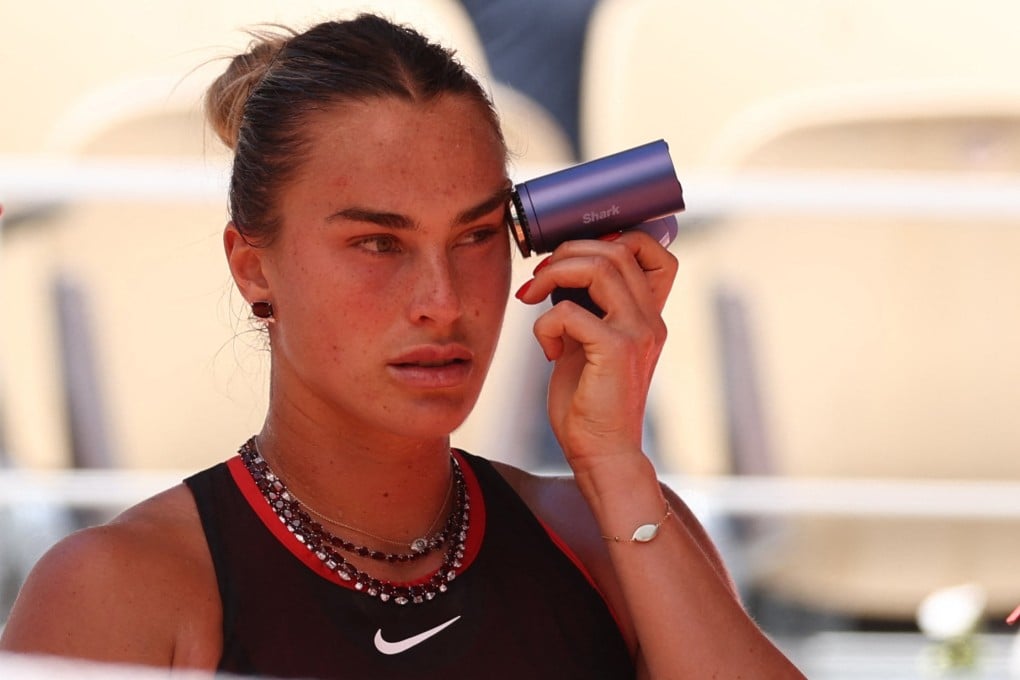 Belarus’ Aryna Sabalenka uses a handheld fan to cool down during a break in play against Spains’s Jessica Bouzas Maneiro. Photo: Reuters