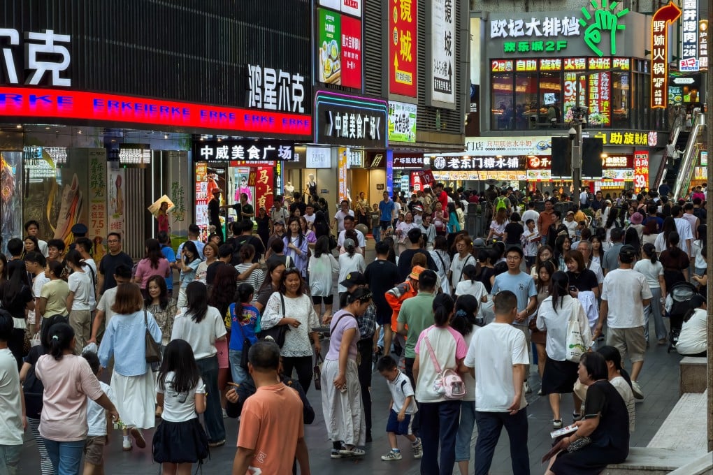 Crowds of pedestrians walk along a busy commercial street in Shenzhen’s Dongmen area on April 18. Photo: Getty Images