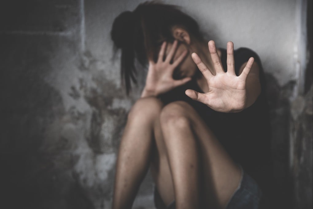A woman raises her hands in fear. A Swedish woman is demanding the equivalent of US$120,000 in damages if her husband is found guilty of prostituting her out to over 100 clients. Photo: Shutterstock