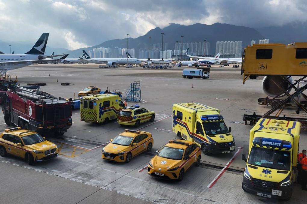 Ambulances wait at Hong Kong International Airport on Saturday morning for the Brisbane flight. Photo: Handout