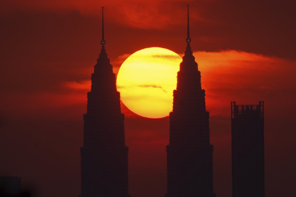 The sun sets behind the Petronas Twin Towers in Kuala Lumpur. Photo: AP