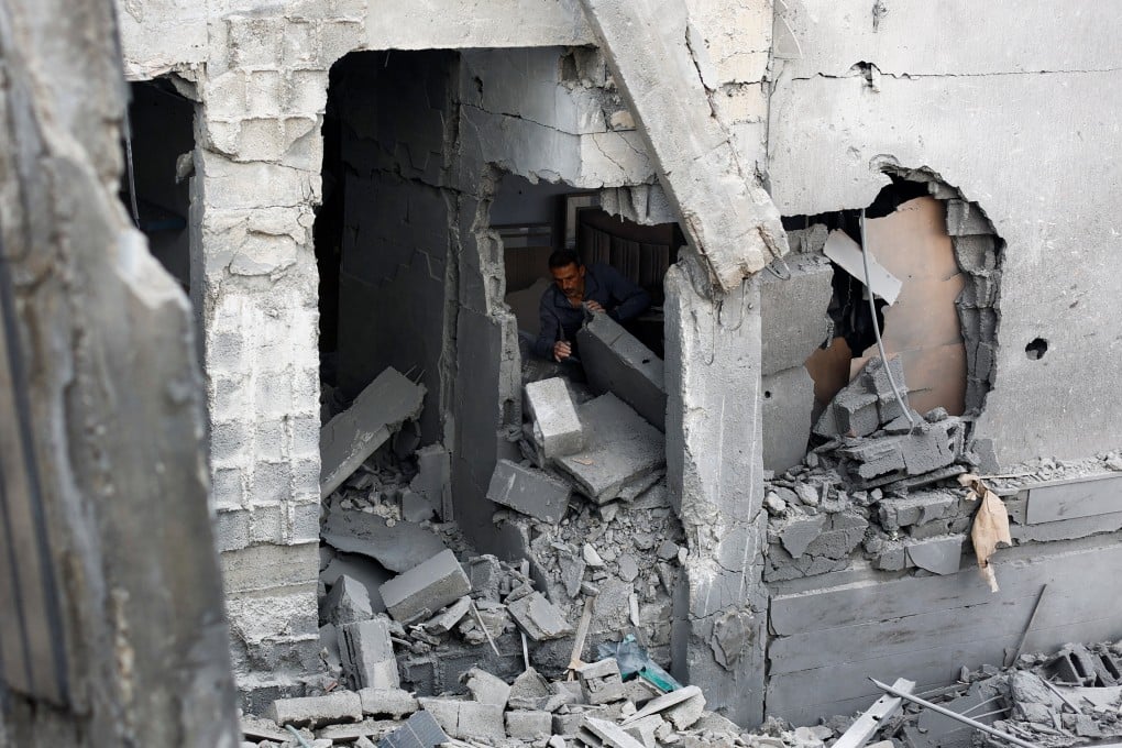 A Palestinian man inspects the site of an Israeli strike on a Gaza City residential building. Photo: Reuters