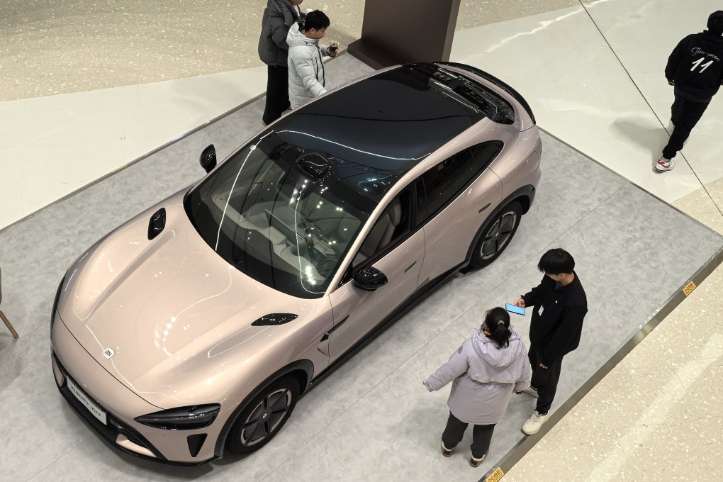 People check the Xiaomi YU7 new energy (EV) car in a new shopping mall in Beijing. Photo: Simon Song
