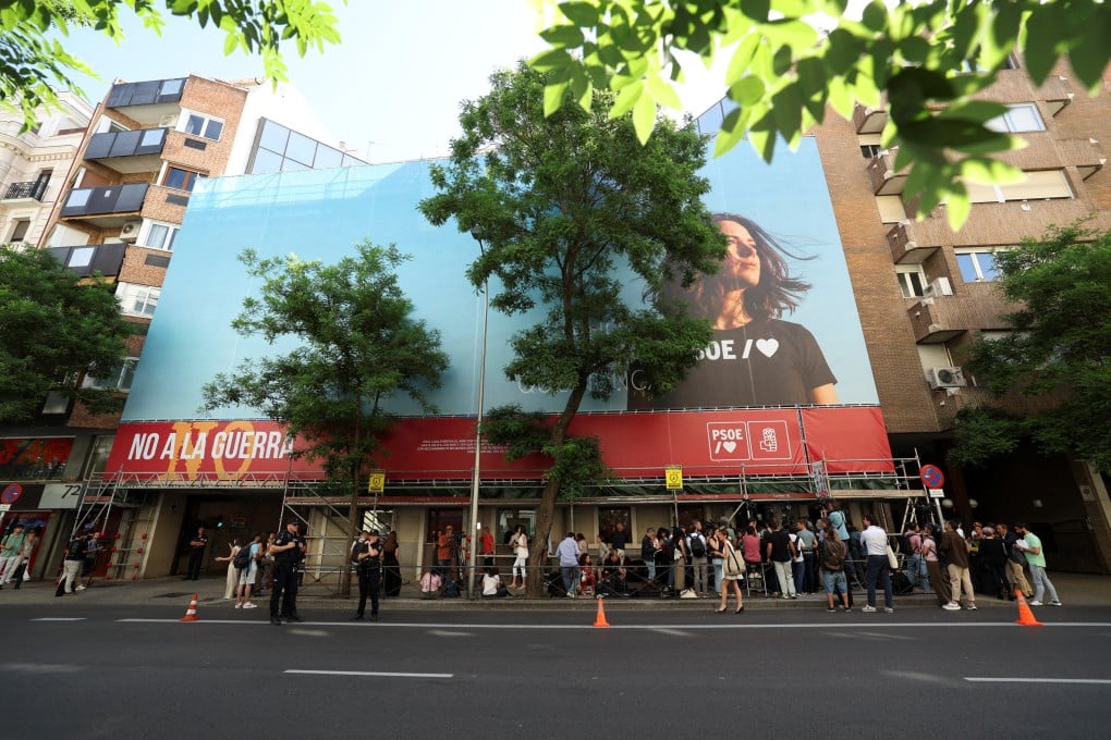 Members of the media gather outside the Socialist Party’s headquarters as Spanish police cordon off access to on a judicial order to gather information on a possible illegal financing scheme, in Madrid on Wednesday. Photo: Reuters