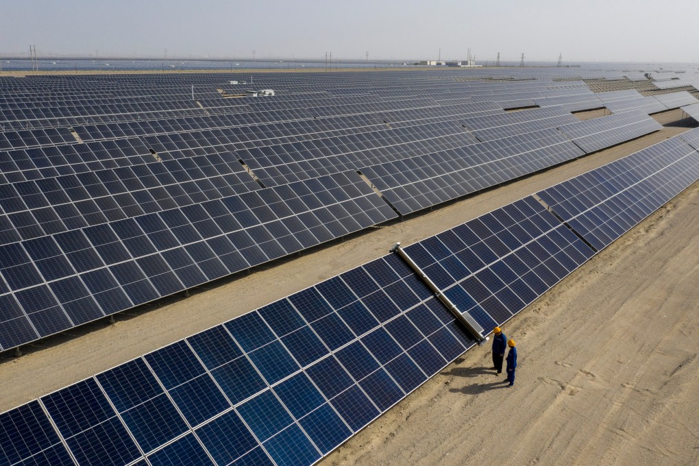 Workers inspect a vast solar power project in western China. Photo: Xinhua