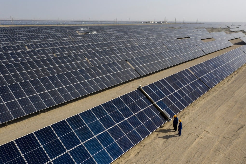 Workers inspect a vast solar power project in western China. Photo: Xinhua