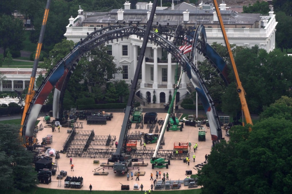 Cranes lift giant metal arches into place for the UFC event. Photo: AP