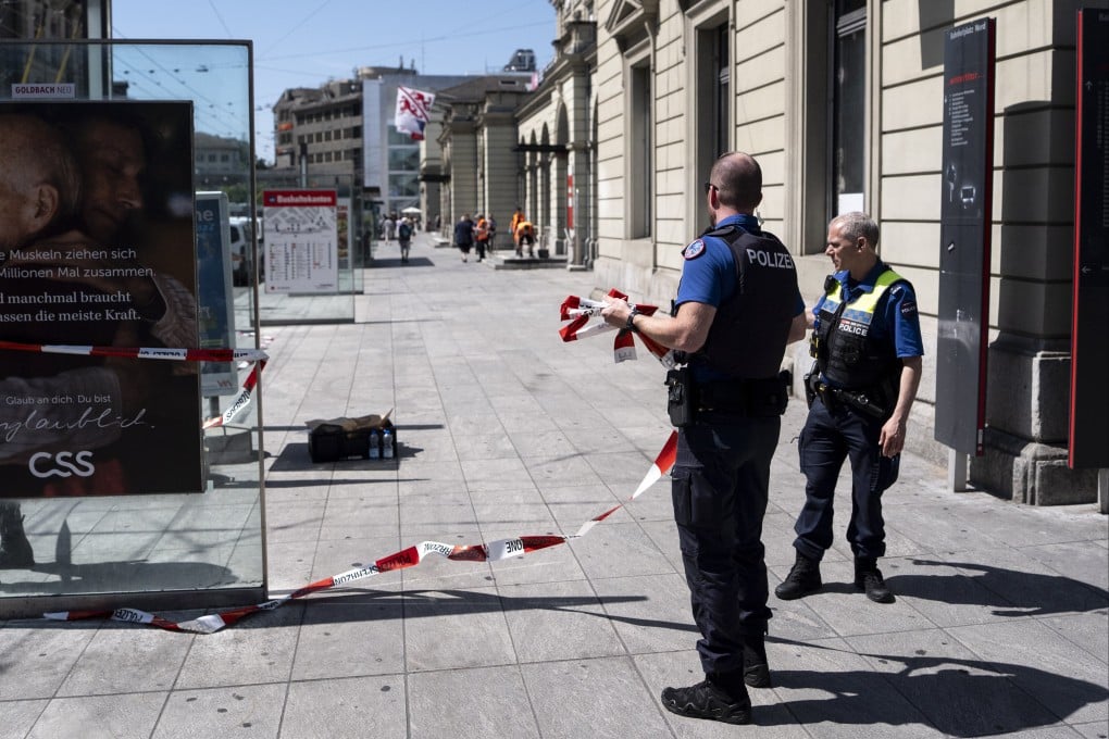 Police officers remove barrier tape at the scene of a stabbing incident at the railway station in Winterthur, Switzerland on Thursday. Photo: EPA