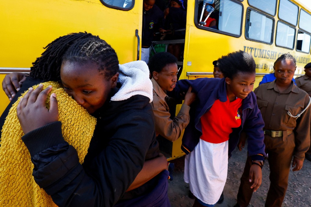 A student injured in a stampede is assisted as she disembarks from the school bus at the Utumishi Girls’ Academy Senior School following an overnight fire in a dormitory at the facility in Gilgil, Nakuru county, Kenya on Thursday. Photo: Reuters
