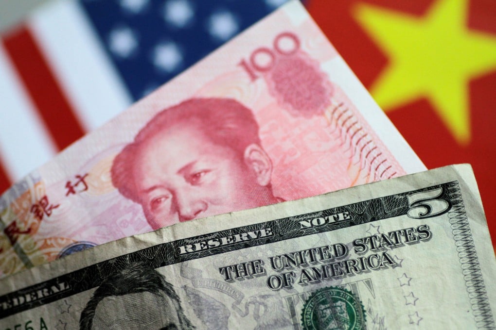US dollar and Chinese yuan notes are seen with national flags in the backdrop. Photo: Reuters