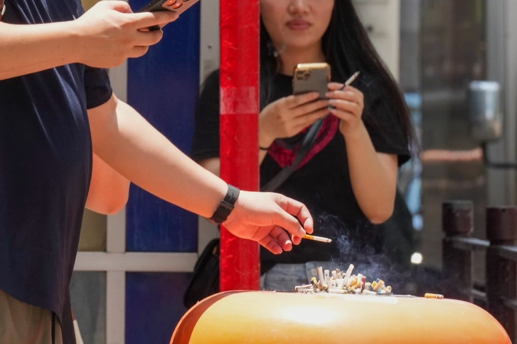 People smoke beside a rubbish bin in Tsim Sha Tsui on May 27. Photo: Jelly Tse
