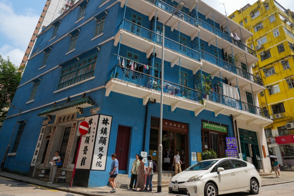People walk past “Blue House”, a four-storey tenement block on Stone Nullah Lane, Wan Chai, on August 29, 2024. Photo: May Tse