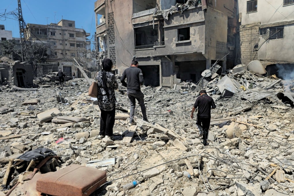 People inspect the site of an Israeli strike in Tyre, Lebanon on Thursday. Photo: Reuters