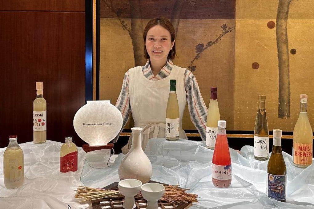 Sky Oh, the founder of Hong Kong-based Korean alcohol distributor Fermentation Heaven, is surrounded by a variety of Korean drinks, including Korean rice wine. Her company recently provided Korean rice wines for an event at Shenzhen’s Otheroof. Photo: Sky Oh