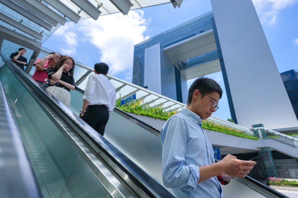 Civil servants and others ride an escalator near the government’s headquarters in Tamar, Admiralty, on May 28. Photo: Karma Lo