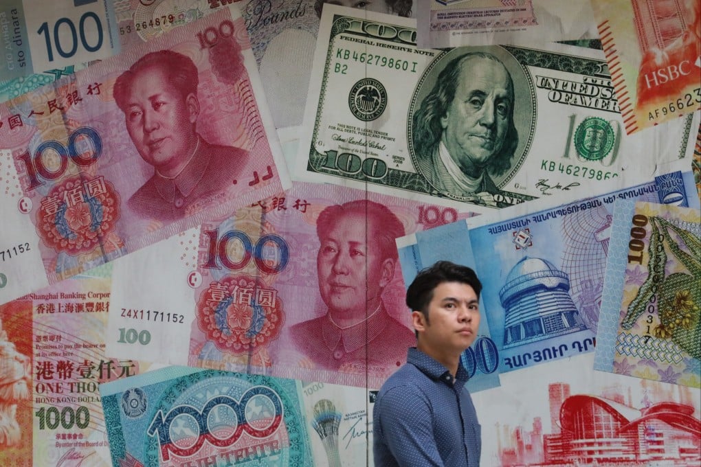 A man walks past a money exchange shop in Central, Hong Kong. The nation’s latest five-year plan calls on Hong Kong to enhance its role as an international financial hub and expand its offshore renminbi business.Photo: Felix Wong