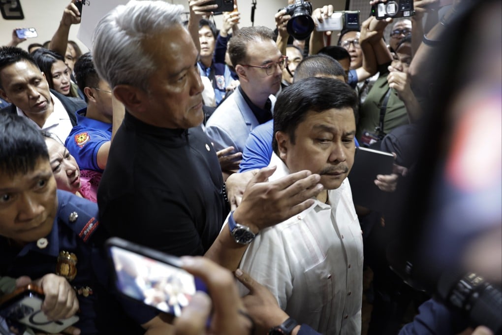 Philippine Senator Jinggoy Estrada (right) is escorted by Department of Interior and Local Government Secretary Jonvic Remulla (left), as Estrada leaves the Senate to surrender to police authorities, in Metro Manila, on Monday. Photo: EPA