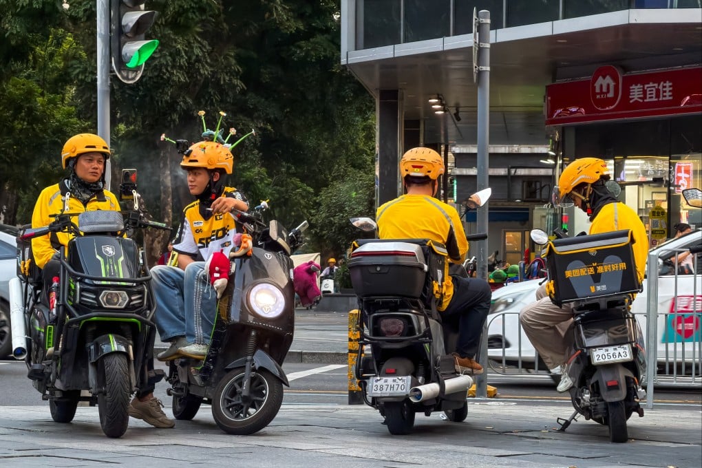 Meituan delivery riders wait for orders at an intersection in Shenzhen, March 24, 2026. Photo: Getty Images