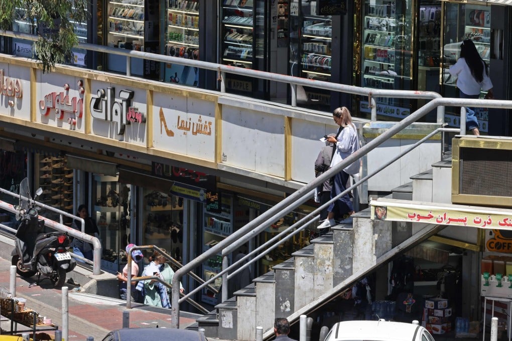 Life goes on around a shopping arcade in Tehran on May 31. Washington’s strategy rests on a Western fantasy: that a heavily sanctioned authoritarian state will simply collapse quietly. History says otherwise. Photo: AFP