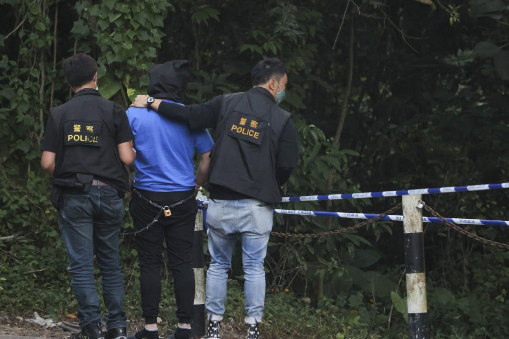 One of the suspects being escorted by police officers on a hillside near Ping Yeung Village in Ta Kwu Ling after the 2022 murder. Photo: Jelly Tse