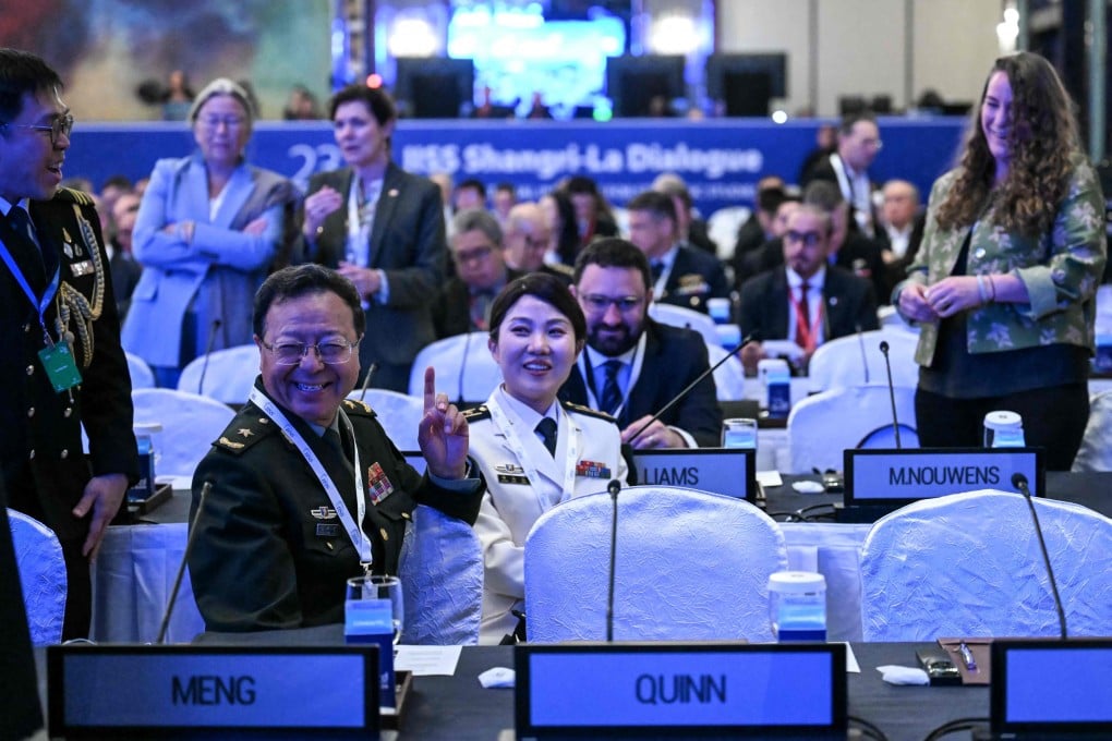 Major General Meng Xiangqing (left) of the PLA National Defence University, and head of the Chinese delegation, gestures as he attends the 23rd Shangri-La Dialogue forum in Singapore on May 31. Photo: AFP