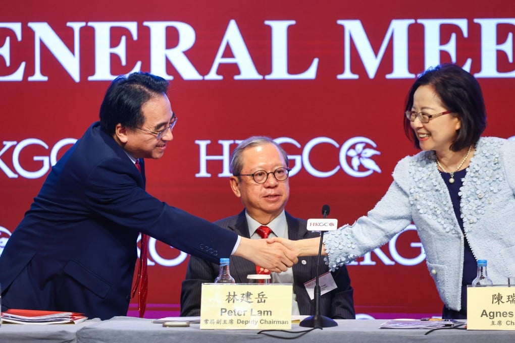 Jacob Kam (left) shake hands with Agnes Chan as chamber deputy chairman Peter Lam Kin-ngok looks on. Photo: Dickson Lee