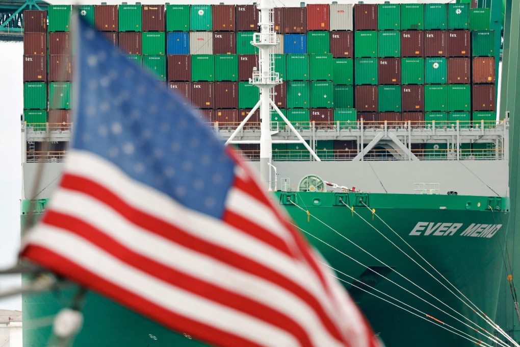 An American flag flies near a container ship at the Port of Los Angeles in May. Photo: AP