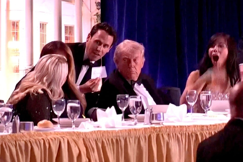 A staff member shows a note to US President Donald Trump, first lady Melania Trump and White House Press Secretary Karoline Leavitt, as CBS News senior White House correspondent Weijia Jiang reacts to a loud noise during the annual White House Correspondents’ Association dinner in Washington in April. Photo: Reuters