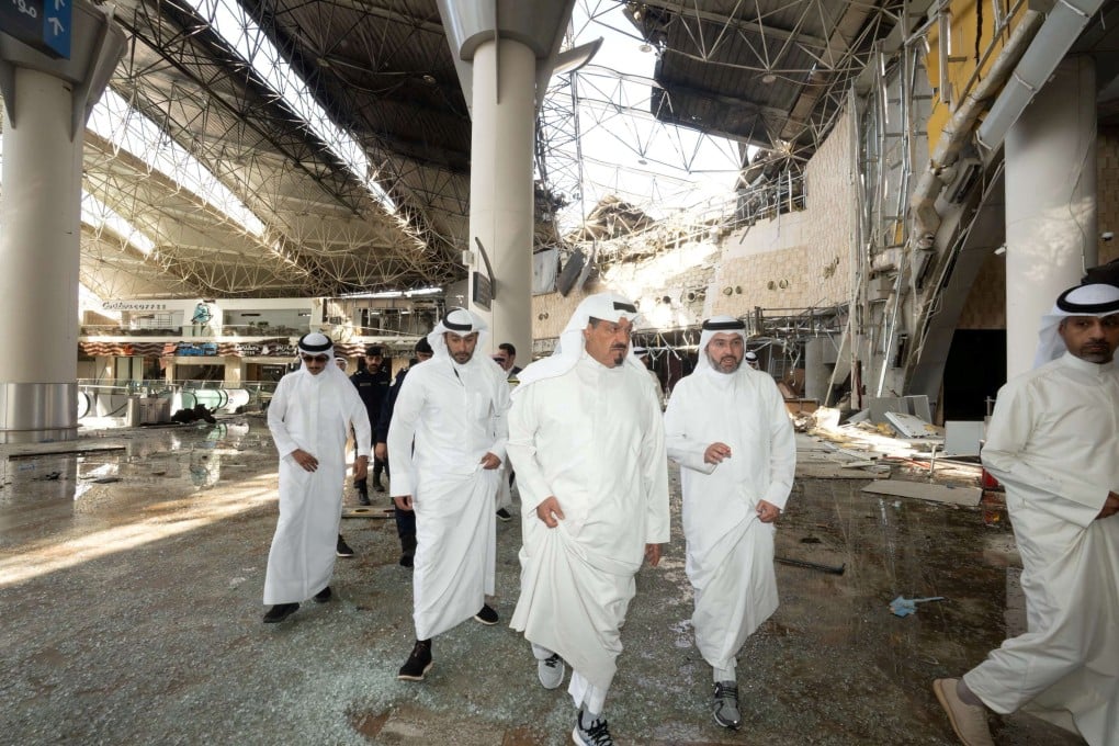 Kuwaiti officials inspect damage inside a terminal at Kuwait International Airport following a drone and missile attack. Photo: Kuwait News Agency via Reuters