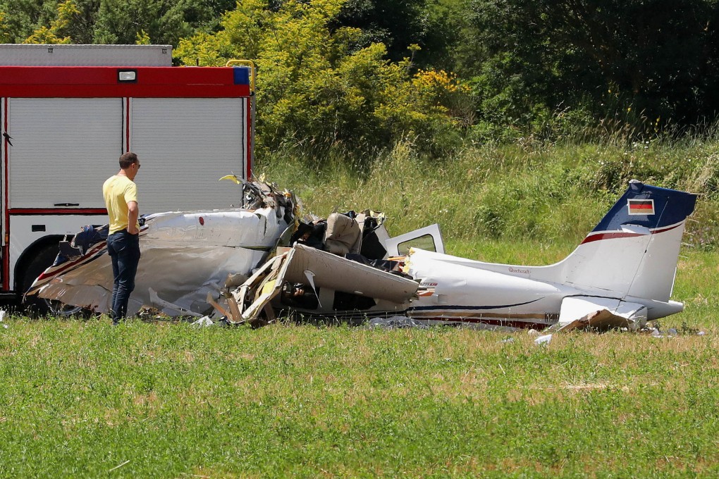 A person inspects a small plane which crashed near Medulin, Croatia on Thursday. Photo: AP
