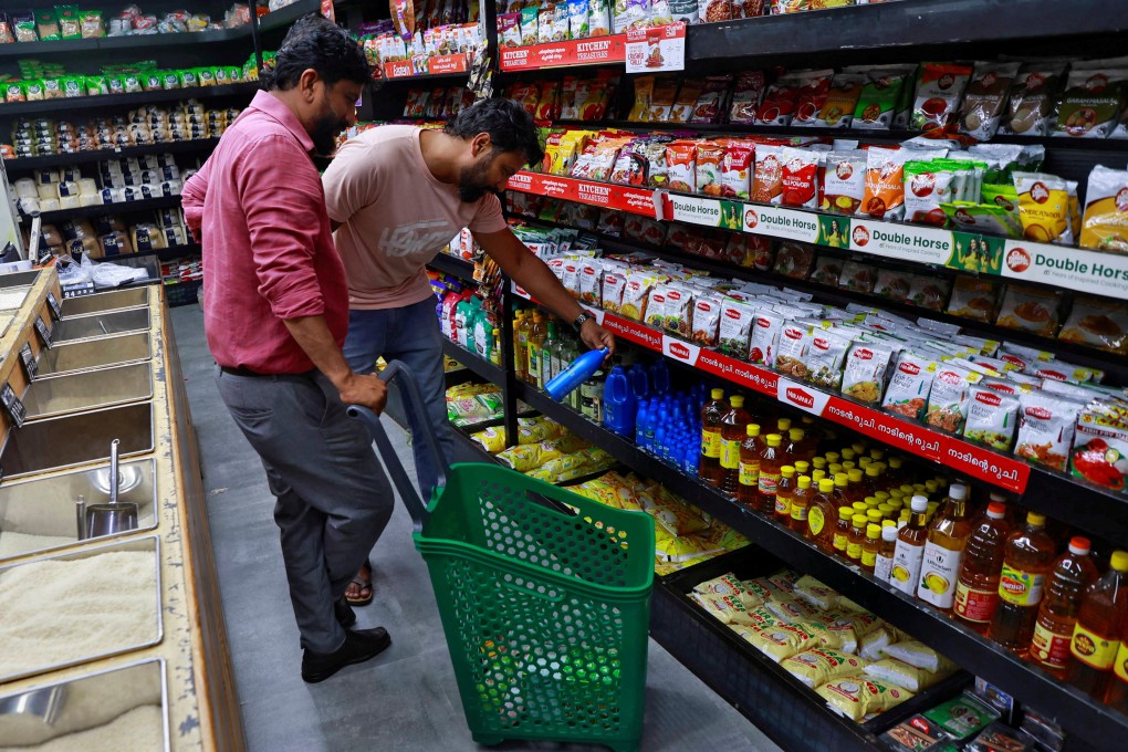 Customers check out products at a retail store in Kochi, India. Photo: Reuters