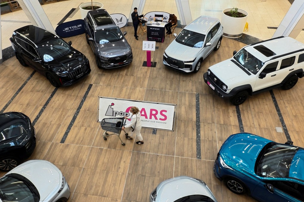 A shopper passes a display of Chinese-made cars, including models from Chery and Omoda, in a shopping centre in Johannesburg, South Africa, on April 23. Photo: Reuters