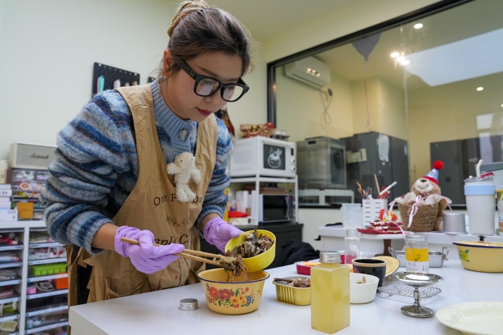 Baker Ding Yifan prepares pet food in Wuxi,  Jiangsu province, in February. Photo: Xinhua