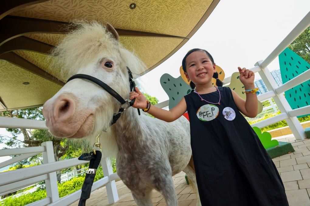Audrey Wong, 3, got the chance to meet some of the new inhabitants of Pony World. Photo: Dickson Lee