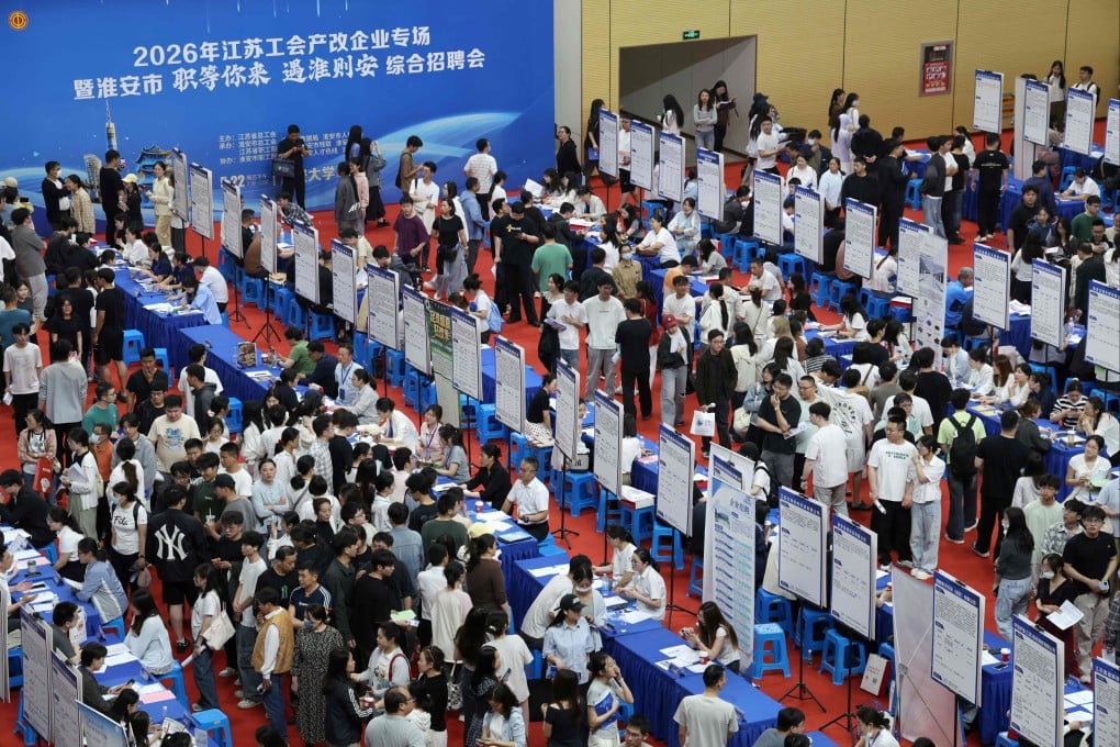 Jobseekers survey recruitment notices at a job fair targeting university graduates at Huaian University in Huaian, Jiangsu province, on May 22. Photo: AFP
