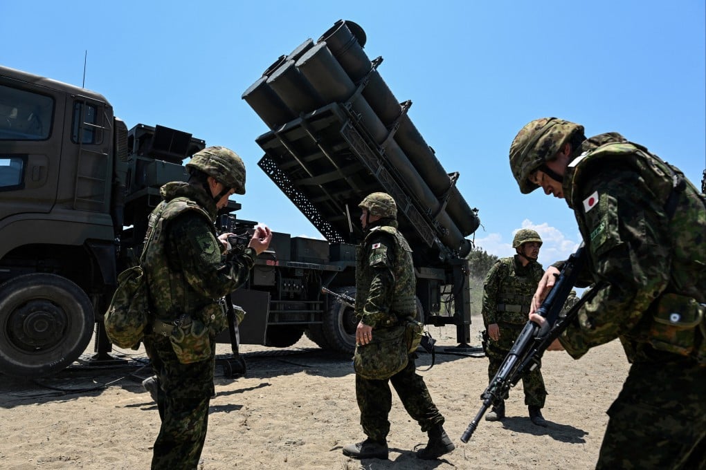 Japan Ground Self-Defence Force soldiers walk in front of a Type 88 surface-to-ship missile launcher during military drills in the Philippines on May 6. Photo: Reuters