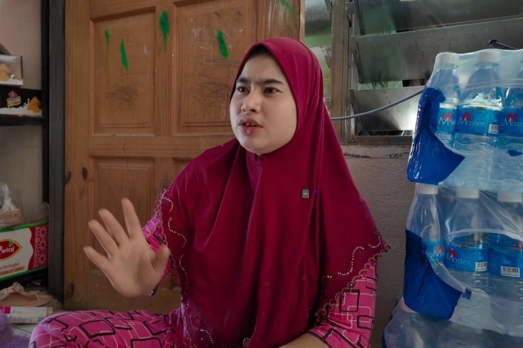 Nurul Nisa speaks inside her sundry shop in Langkawi, Malaysia. She is among thousands of Rohingya who have fled Myanmar to Malaysia and elsewhere in recent years. Photo: Ushar Daniele