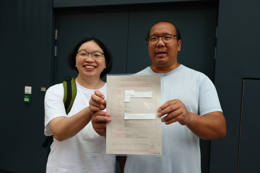 Kwan Pui-sin and Tsang Wai-bong with their son Danny’s birth certificate at the Immigration Department in Tseung Kwan O. Photo: Dickson Lee