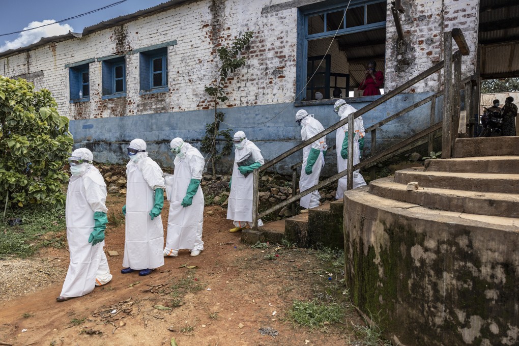 Health workers wearing protective equipment walk outside the General Referral Hospital during the Ebola outbreak response on May 21, in Mongbwalu, Democratic Republic of Congo. Photo: TNS