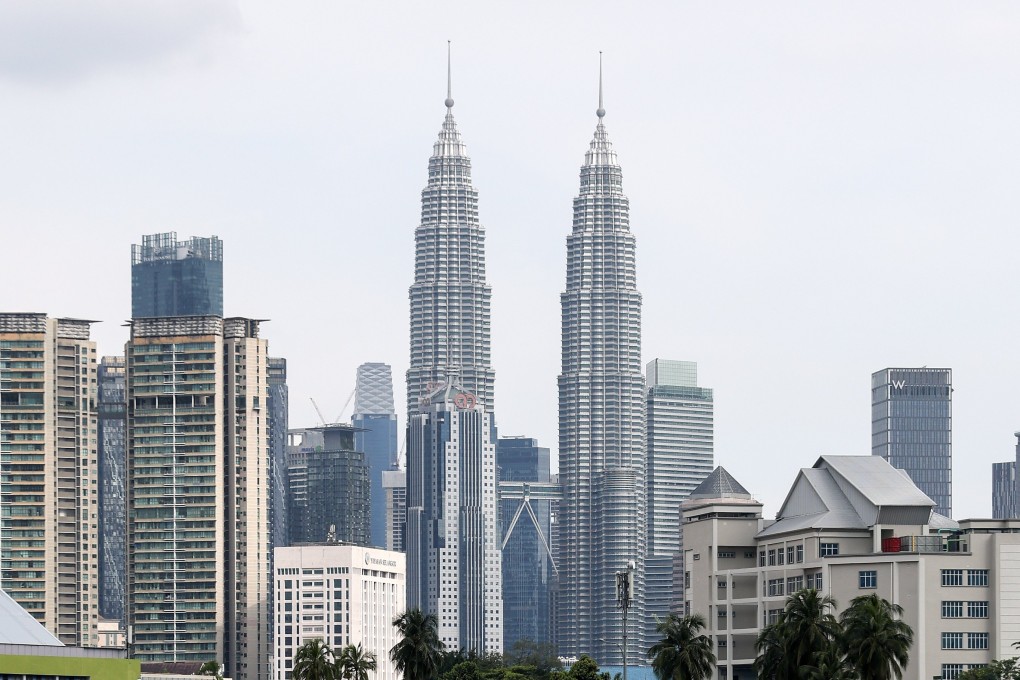 Malaysia’s iconic Petronas Twin Towers in Kuala Lumpur. The country has announced a crackdown against illegal businesses run by foreigners. Photo: EPA
