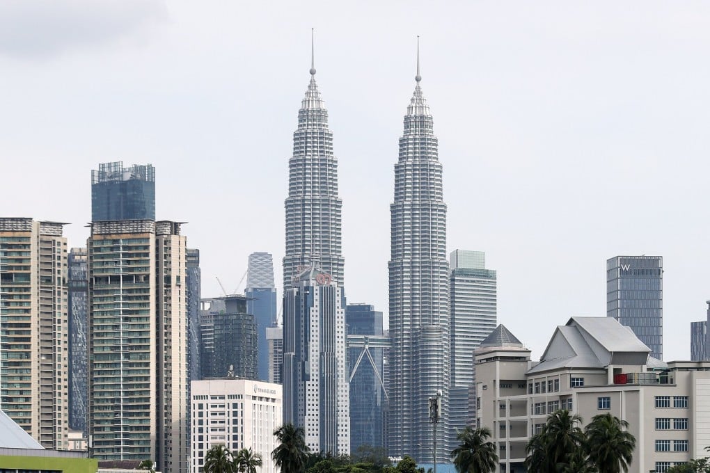 Malaysia’s iconic Petronas Twin Towers in Kuala Lumpur. The country has announced a crackdown against illegal businesses run by foreigners. Photo: EPA