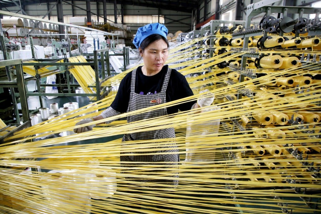 A worker monitors products at a packaging factory in Lianyungang, in China’s eastern Jiangsu province on May 18. Photo: CN-STR/AFP