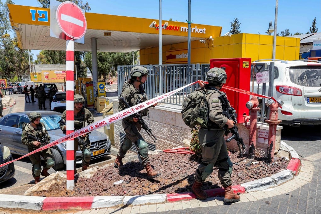 Israeli security forces gather at a petrol station following a shooting near the town of Kokhav Yair in central Israel close to the occupied West Bank on Sunday. Photo: AFP